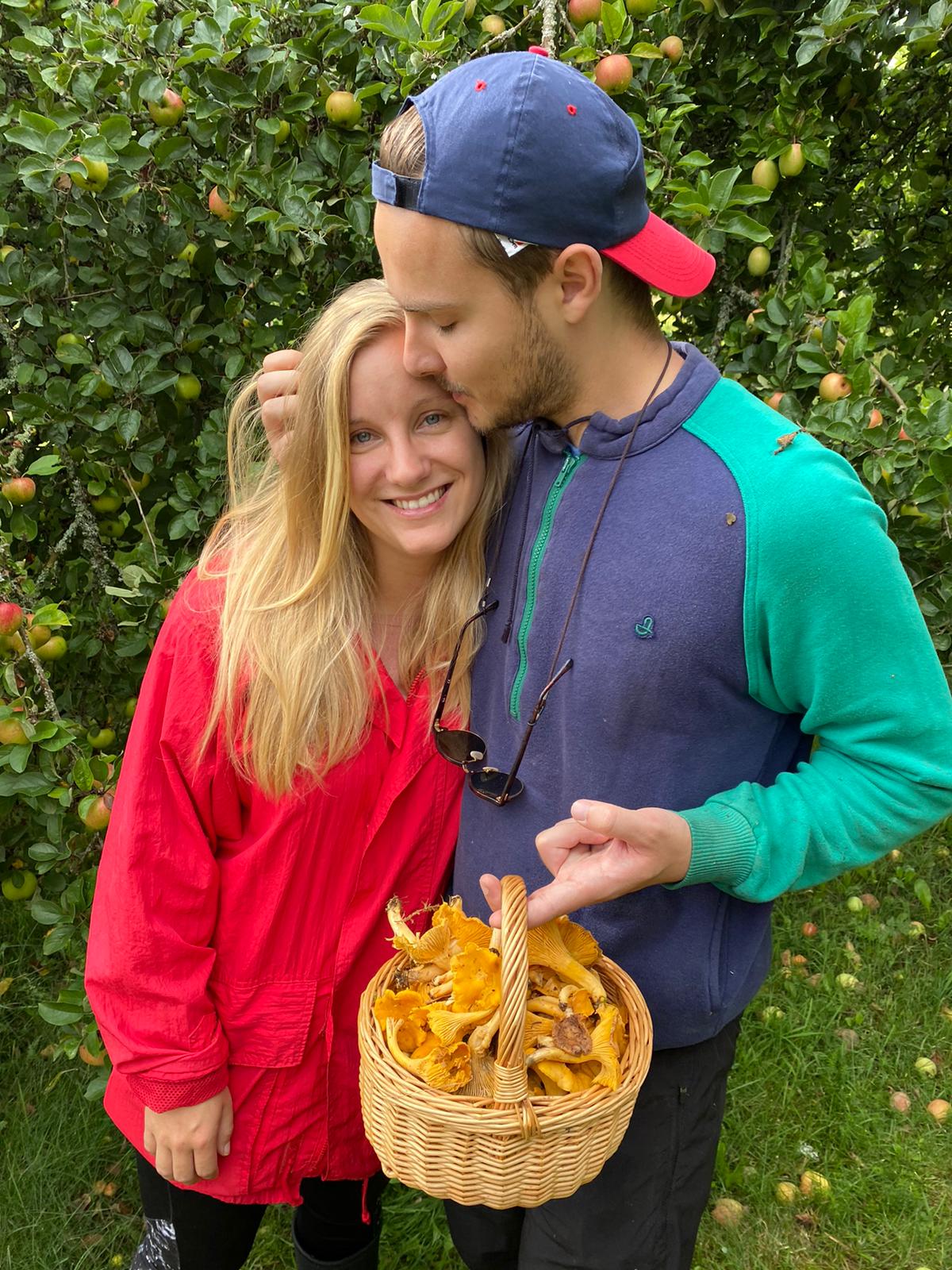 Linnea and Olle in the orchard with a basket of chanterelles